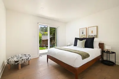 a white bedroom with a large bed and a window at La Jolla Hillside Views and Coastal Comfort in San Diego