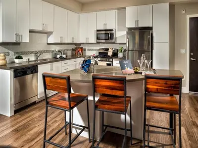 a kitchen with a center island with two bar stools at Ariva in San Diego