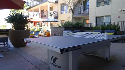 a ping pong table in front of a building at Ariva in San Diego