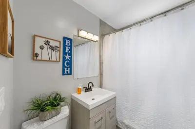 a white bathroom with a sink and a toilet at Charming Gem in LH, High Speed WiFi Minutes from Beach, Downtown & Petco Park! in San Diego