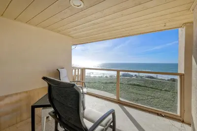 a balcony with a chair and a view of the ocean at Aqua Luxe - SUR113 in Solana Beach