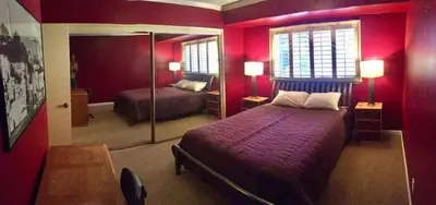 a red bedroom with a bed and a mirror at Room in Bay Park, San Diego in San Diego
