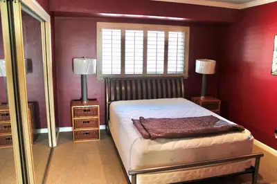 a bedroom with a bed and two lamps and a window at Room in Bay Park, San Diego in San Diego