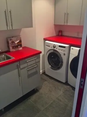 a small kitchen with a washing machine and red counters at Room in Bay Park, San Diego in San Diego