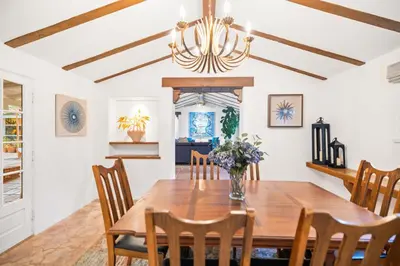 a dining room with a wooden table and a chandelier at Spacious Spanish Hacienda Close to Everything in San Diego
