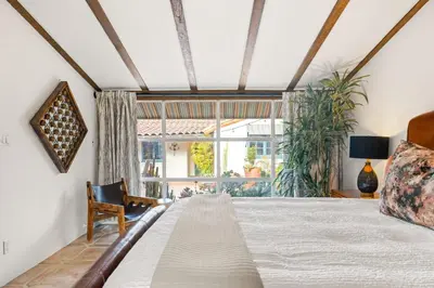 a bedroom with a bed and a large window at Spacious Spanish Hacienda Close to Everything in San Diego