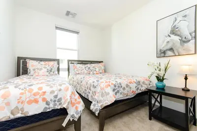 a bedroom with two beds and a table at Modern 2BR Near Petco Park & Convention Center in San Diego