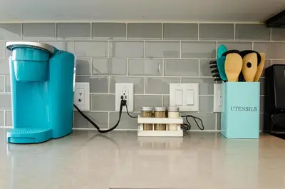 a kitchen with a blue appliance plugged into a wall at Modern 2BR Near Petco Park & Convention Center in San Diego