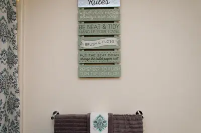 a bathroom with three towels hanging on a wall at Modern 2BR Near Petco Park & Convention Center in San Diego