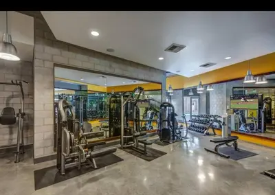 a gym with several tread machines in a room at Modern 2BR Near Petco Park & Convention Center in San Diego