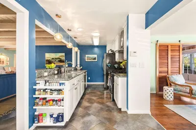 a kitchen with blue walls and a counter top at Boho Oasis with Pool Spa Firepit BBQ Ping Pong in San Diego