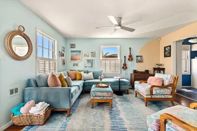 a living room with a blue couch and chairs at Boho Oasis with Pool Spa Firepit BBQ Ping Pong in San Diego