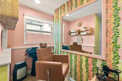 a hair salon with a mirror and a sink at Boho Oasis with Pool Spa Firepit BBQ Ping Pong in San Diego