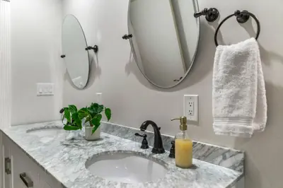 a bathroom with a sink and a mirror at Spacious House close to Petco Park and Gaslamp in San Diego