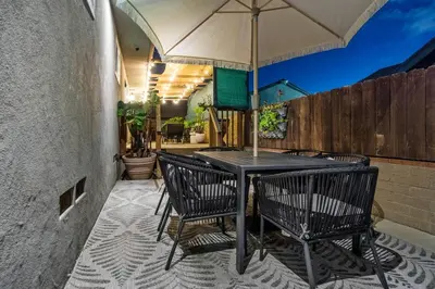 a table and chairs with an umbrella on a patio at Spacious House close to Petco Park and Gaslamp in San Diego