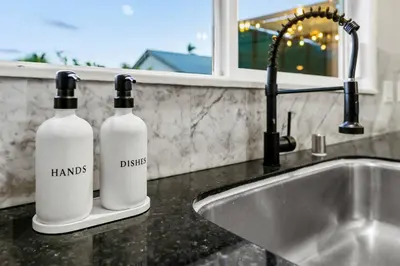 two bottles sitting on a counter next to a sink at Spacious House close to Petco Park and Gaslamp in San Diego