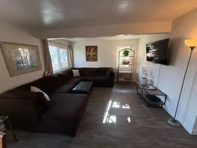 a living room with a couch and a tv at Mission Beach Bayside Beachy Duplex Flat- 2br 1ba- Sleeps 6 Steps to Beach Bay and Belmont Park in San Diego