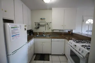 a white kitchen with a stove and a sink at Mission Beach Bayside Beachy Duplex Flat- 2br 1ba- Sleeps 6 Steps to Beach Bay and Belmont Park in San Diego