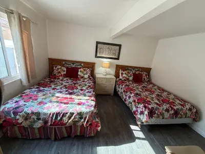 a bedroom with two beds and a table with a lamp at Mission Beach Bayside Beachy Duplex Flat- 2br 1ba- Sleeps 6 Steps to Beach Bay and Belmont Park in San Diego