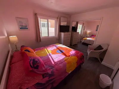 a bedroom with a bed with a colorful blanket at Mission Beach Bayside Beachy Duplex Flat- 2br 1ba- Sleeps 6 Steps to Beach Bay and Belmont Park in San Diego