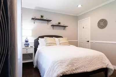 a bedroom with a bed with white sheets and pillows at Feel At Home In MV - 'Good Vibes Only' Mentality in Mission Viejo