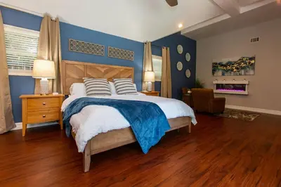 a bedroom with a large bed with blue walls at Feel At Home In MV - 'Good Vibes Only' Mentality in Mission Viejo