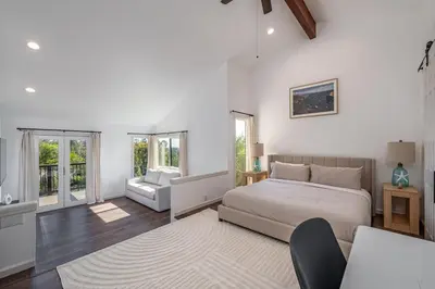 a bedroom with a bed and a living room at Mountain Villa in San Diego - Pool & Waterslide, Spa, Pickle Ball, Game room in La Mesa