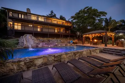 a swimming pool with chairs in front of a building at Mountain Villa in San Diego - Pool & Waterslide, Spa, Pickle Ball, Game room in La Mesa