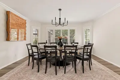 a dining room with a black table and chairs at Casa Verde Wine Country Estate w Pickleball Casita in Temecula