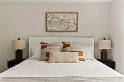 a bedroom with a white bed with two lamps at Casa Verde Wine Country Estate w Pickleball Casita in Temecula