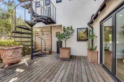 a patio with a spiral staircase and potted plants at European Charm Meets La Jolla Rooftop Views in San Diego