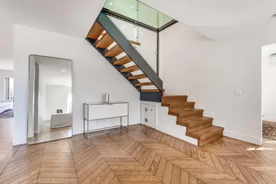 an open living room with a staircase and a mirror at European Charm Meets La Jolla Rooftop Views in San Diego