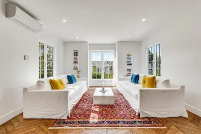 a living room with two white couches and a rug at European Charm Meets La Jolla Rooftop Views in San Diego