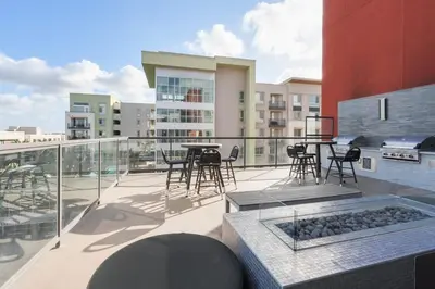 a balcony with a table and chairs on a building at Vive on The Park in San Diego