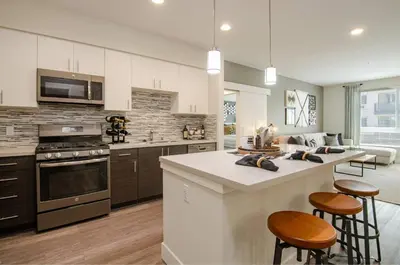 a kitchen with a stove top oven and a counter top at Vive on The Park in San Diego