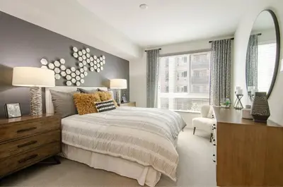 a bedroom with a bed and a desk and a mirror at Vive on The Park in San Diego