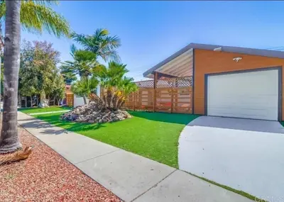 a house with a garage and palm trees at Sunny Retreat Beaches Lakes Trails in La Mesa