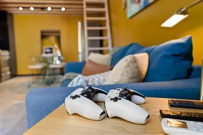 a couple of video game controllers sitting on a table at Sunny Loft Beaches Lakes Trails in La Mesa
