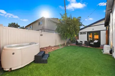 a backyard with a hot tub on the grass at Sunny Loft Beaches Lakes Trails in La Mesa