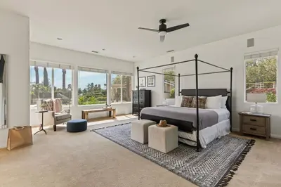 a bedroom with a canopy bed and a rug at Villa Verdot 6BR Estate w Pool Tennis Basketball in Temecula