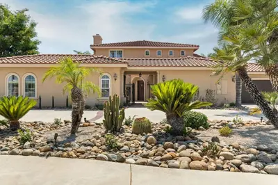 a house with palm trees in front of it at Villa Verdot 6BR Estate w Pool Tennis Basketball in Temecula