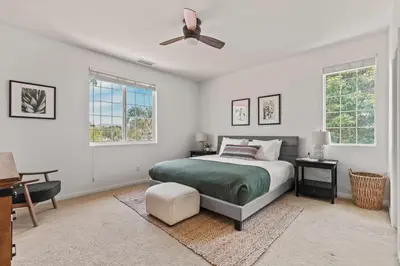 a bedroom with a bed and a ceiling fan at Villa Verdot 6BR Estate w Pool Tennis Basketball in Temecula