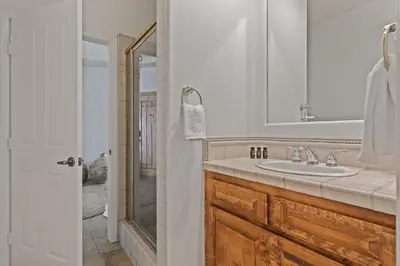 a bathroom with a sink and a mirror at Villa Verdot 6BR Estate w Pool Tennis Basketball in Temecula