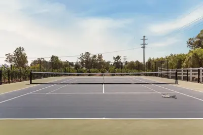 a tennis court with a net on it at Villa Verdot 6BR Estate w Pool Tennis Basketball in Temecula