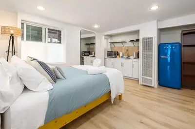 a large bedroom with a large bed and a kitchen at Studio In Carlsbad Village in Carlsbad