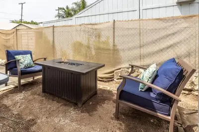 two chairs and a table with a fire pit at Studio In Carlsbad Village in Carlsbad