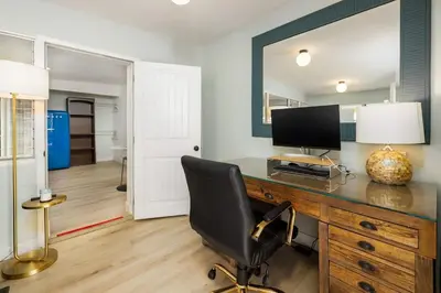 a desk with a computer and a chair in a room at Studio In Carlsbad Village in Carlsbad