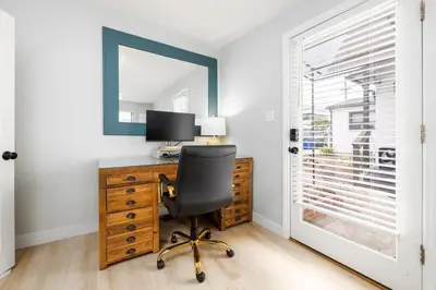 a desk with a computer and a chair in a room at Studio In Carlsbad Village in Carlsbad