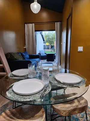 a glass table with plates and glasses on top of it at Events Allowed: Sunny Villa| Lake| Trails| Beach in La Mesa