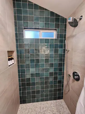a bathroom with a green tiled shower with a window at Events Allowed: Sunny Villa| Lake| Trails| Beach in La Mesa